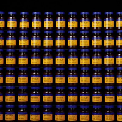Endless Array of Amber Glass Cylinders with Blue Caps